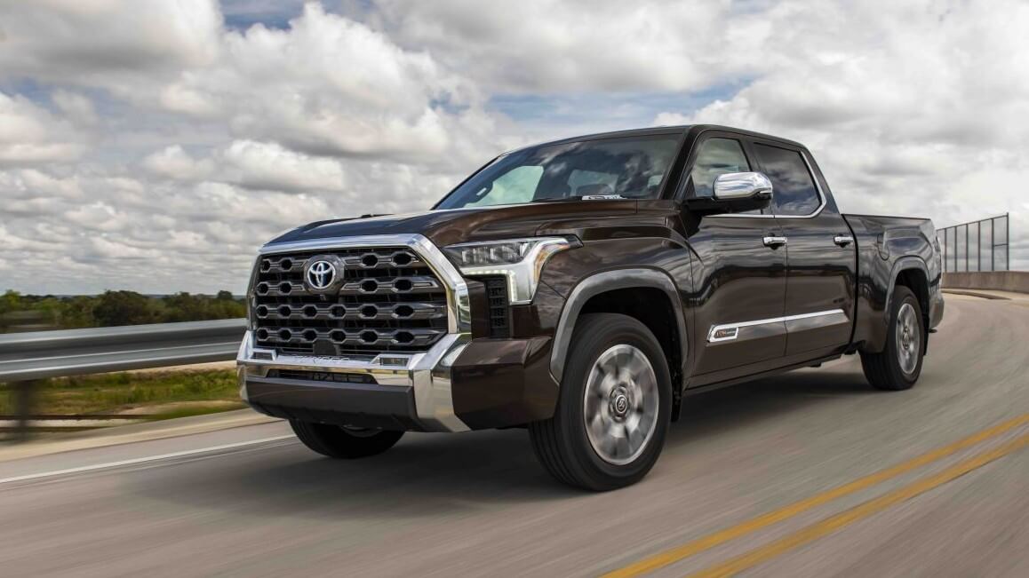 Smoked Mesquite Toyota Tundra driving down a road