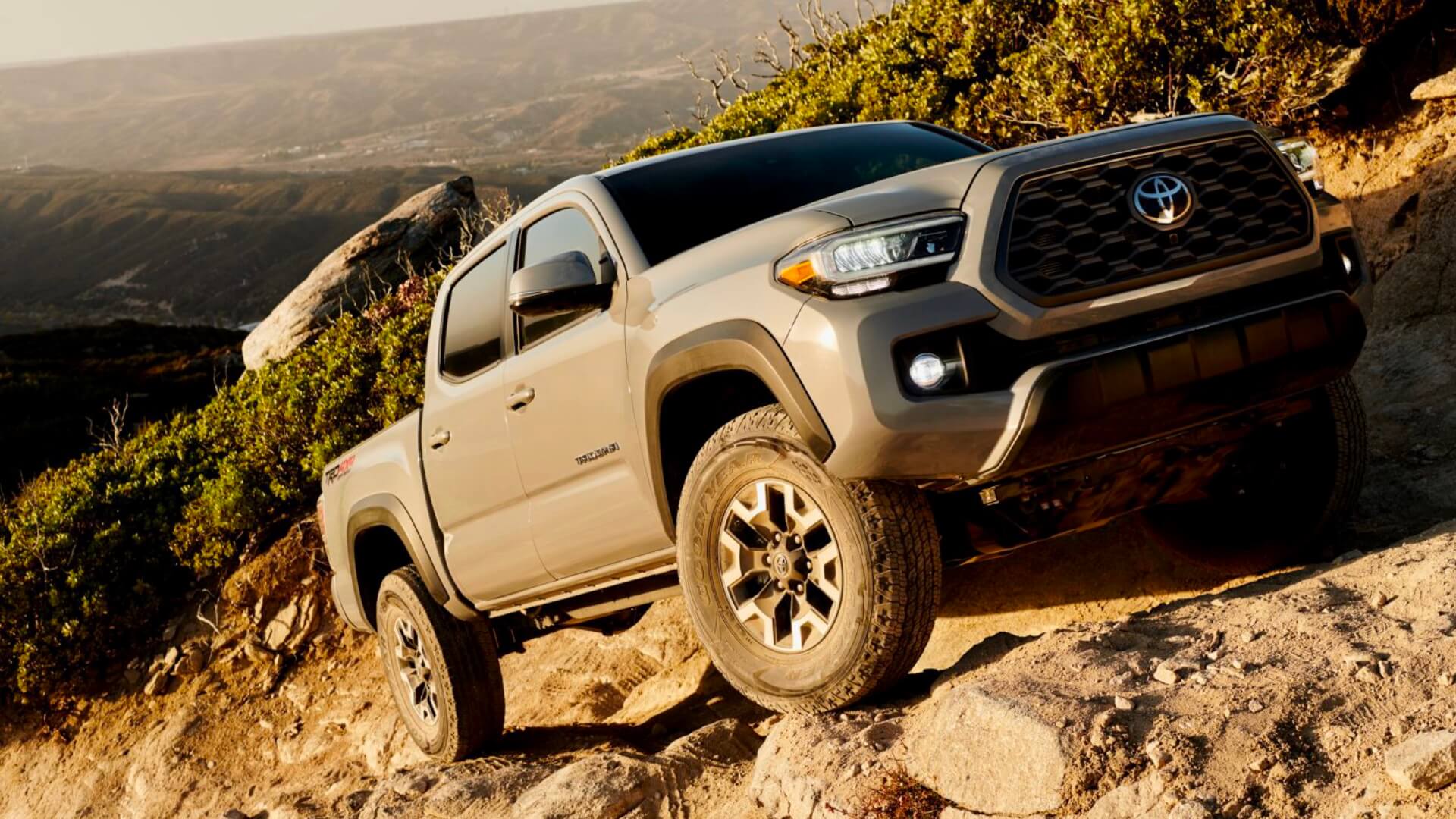 Visit an AutoNation USA Location near you to check out our used Toyota Tacoma inventory Toyota Tacoma driving along a rough rocky trail