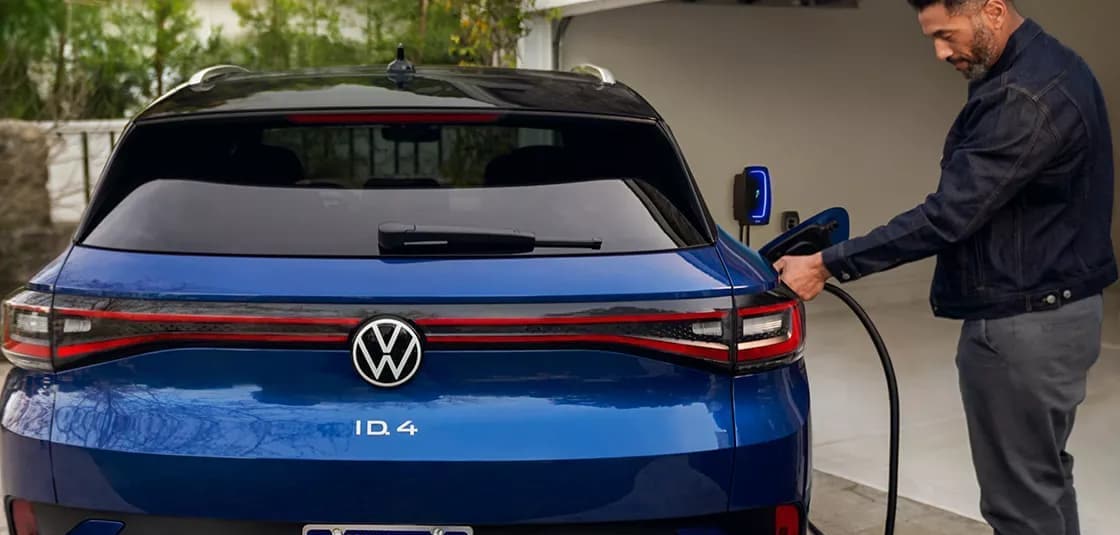 Person plugging in their VW ID.4 EV to their home