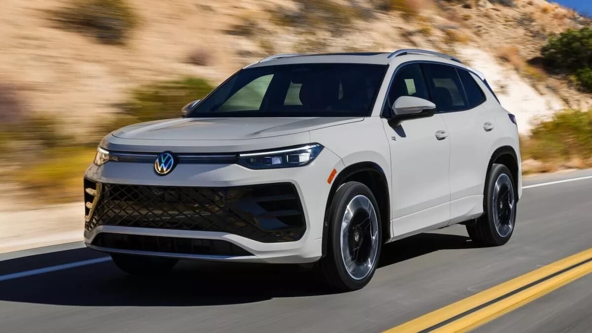 2025 Volkswagen Tiguan in Sandstone driving down the road