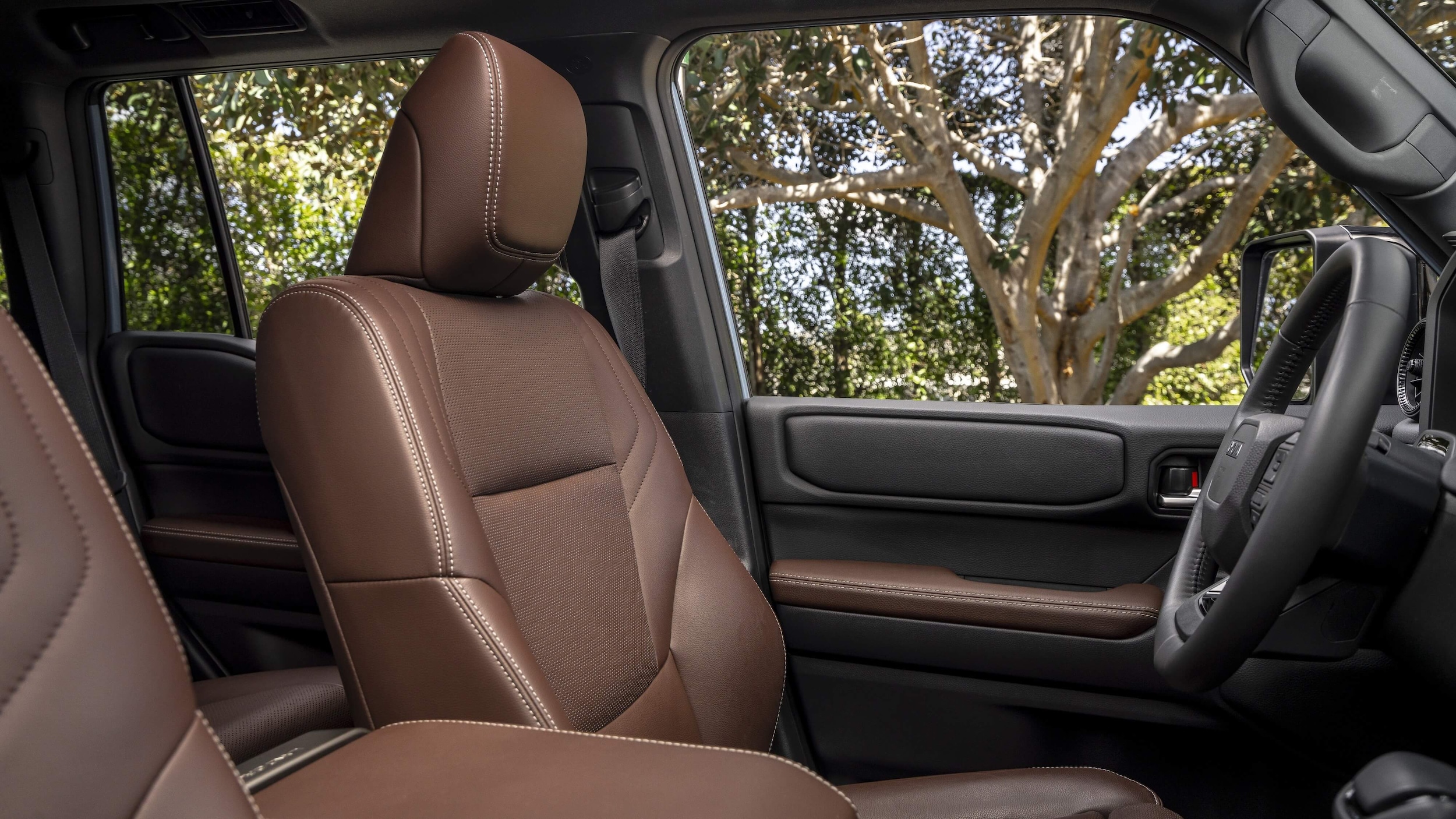 2026_Toyota_LandCruiser_Java_004.jpg The leather driver's seat of the Land Cruiser and a side view of the steering wheel.