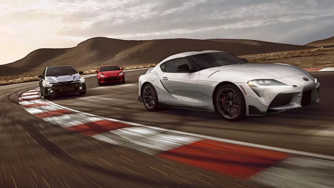 Rendered image of Toyota's GR models, the GR Corolla, GR Supra, and GR86 on a race track