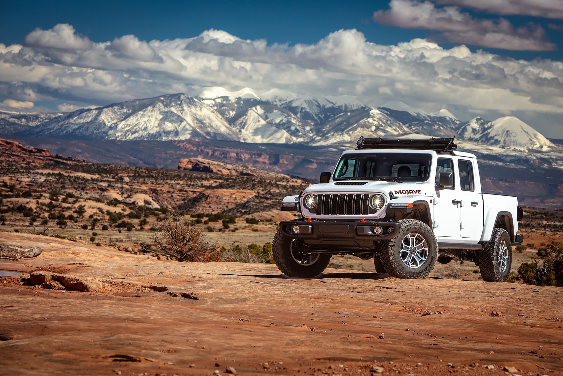 White Jeep Gladiator parked on top of mountain
