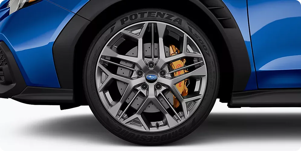 Satin-gray 19-inch alloy wheel on the blue WRX tS