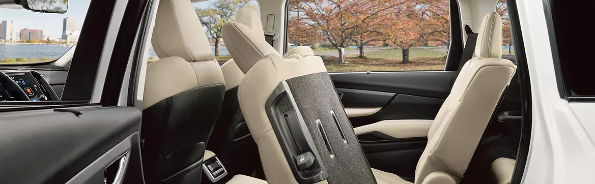 Cream leather-trimmed captain’s chairs and open door of the Subaru Ascent
