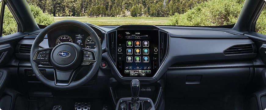 The driver-side dashboard, steering wheel, and multimedia touchscreen of a Subaru Crosstrek