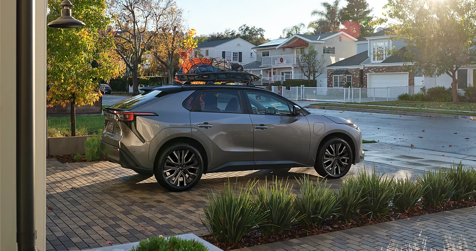 A grey 2026 Subaru Solterra parked in a suburban driveway
