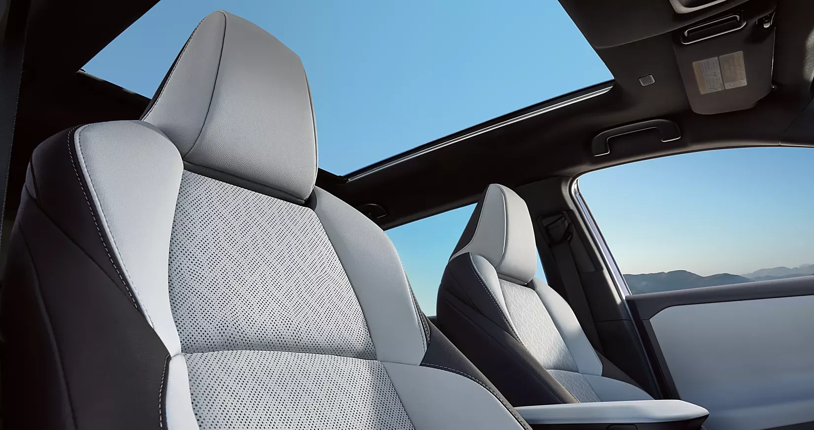 Front seats and panoramic glass roof inside the 2026 Subaru Solterra