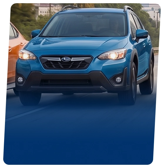 A blue Subaru Crosstrek SUV on a city street