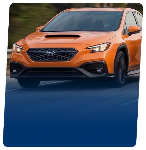 Orange Subaru WRX sedan on a blue backdrop