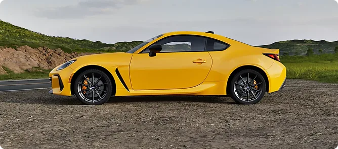 Yellow BRZ Series.Yellow on a green hillside road showing its matte black wheels