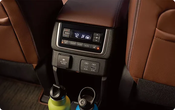 Rear climate controls, USB ports, and cup holders behind the Ascent center console