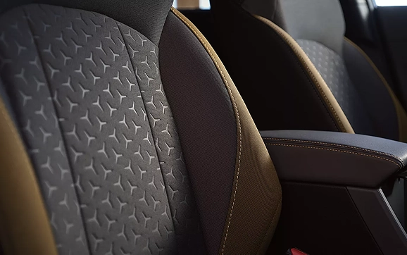 A close-up of the patterned StarTex upholstery and orange stitching on a Subaru Crosstrek seat
