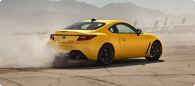 Yellow BRZ Series.Yellow sliding through dust on a test track