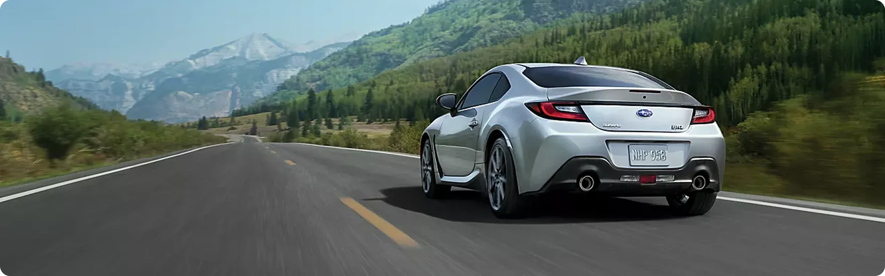 Rear view of a silver Subaru BRZ on a mountain highway