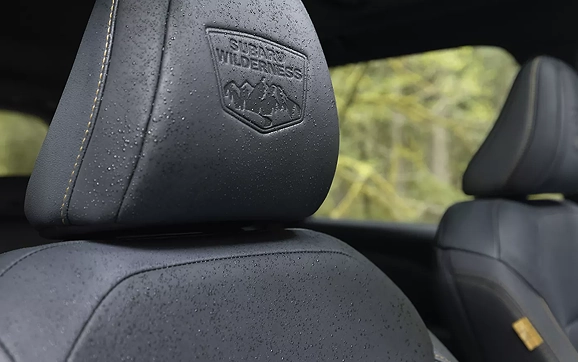 A Subaru Forester Wilderness seat headrest with the embroidered Wilderness logo
