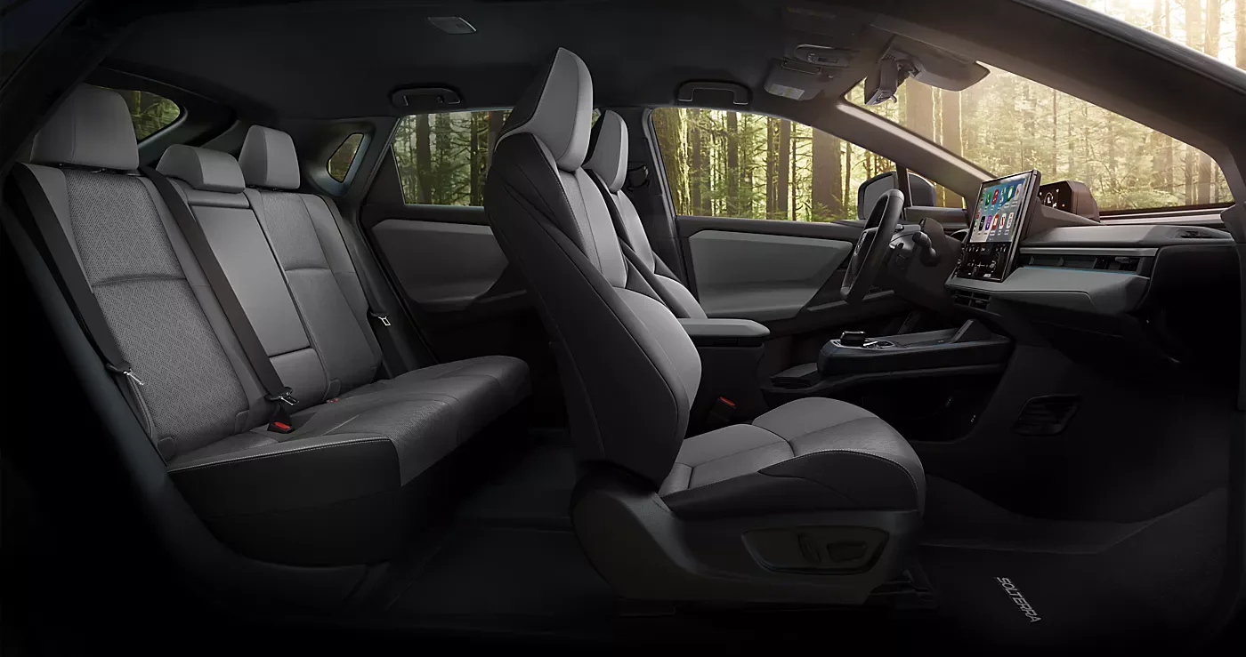 The front and rear seats of the 2026 Subaru Solterra seen through an open door