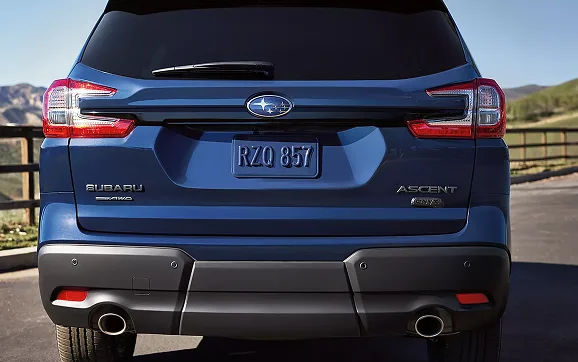 Rear view of a blue Subaru Ascent showing tail lights and dual exhaust