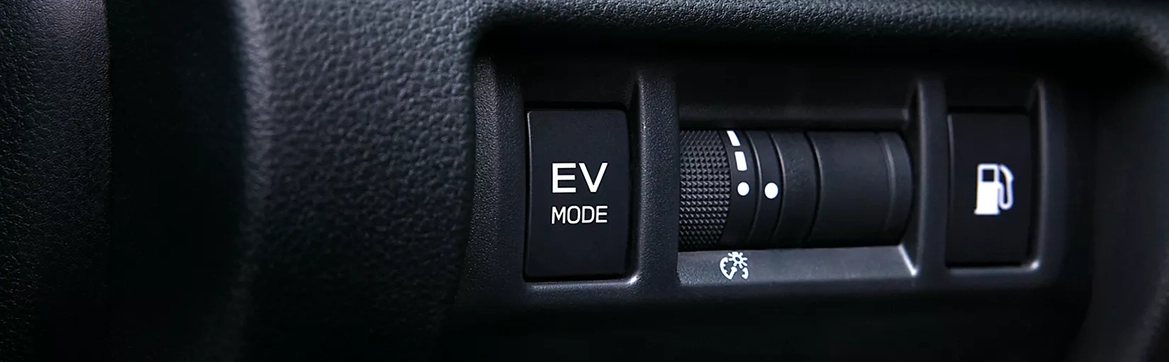 The EV Mode button and drive-mode dial on the center console of a Subaru Crosstrek Hybrid