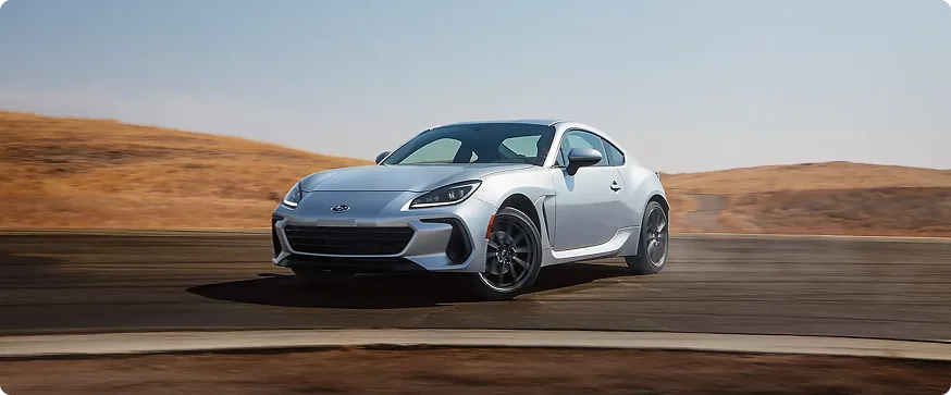A silver Subaru BRZ on a desert road