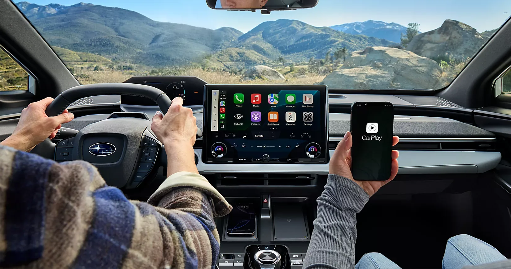 A driver using the Solterra touchscreen with a smartphone connected