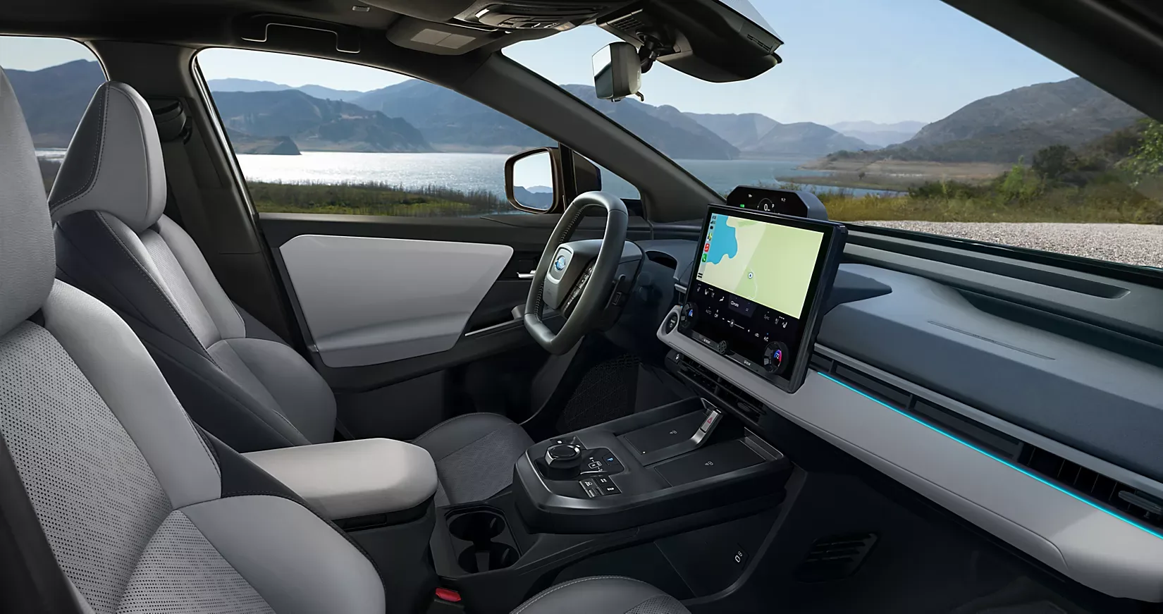 The 2026 Subaru Solterra cabin and 14-inch touchscreen with a lake view ahead