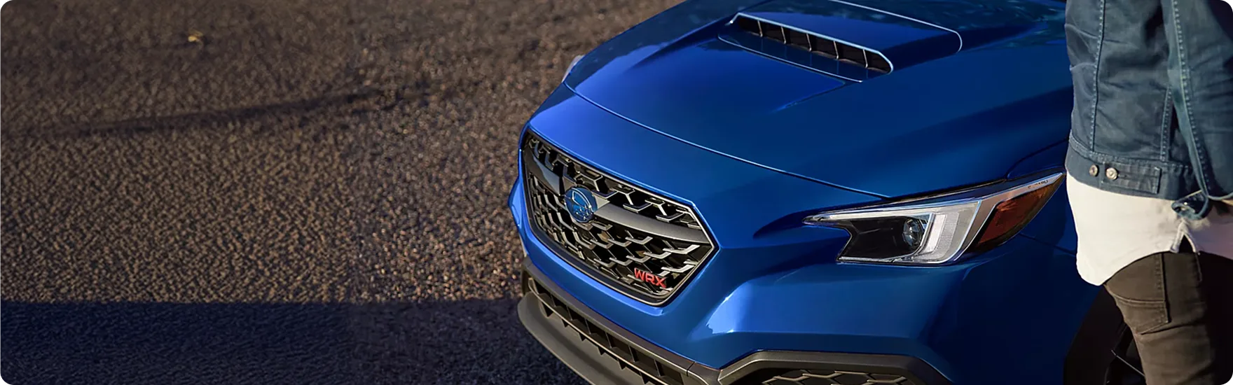 Close-up of the blue WRX front fender and hood scoop