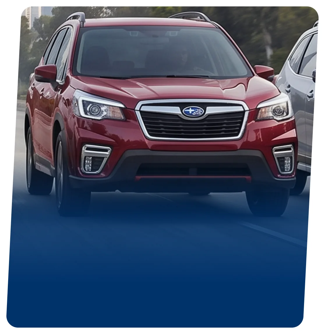 Red Subaru Forester hybrid on a blue backdrop