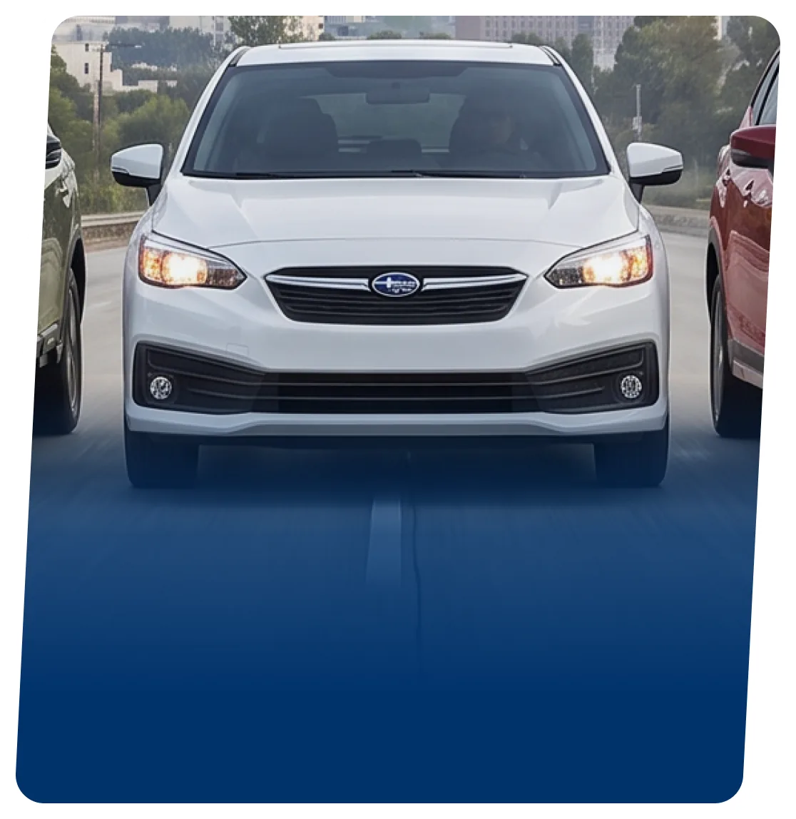 White Subaru Impreza hatchback on a blue backdrop