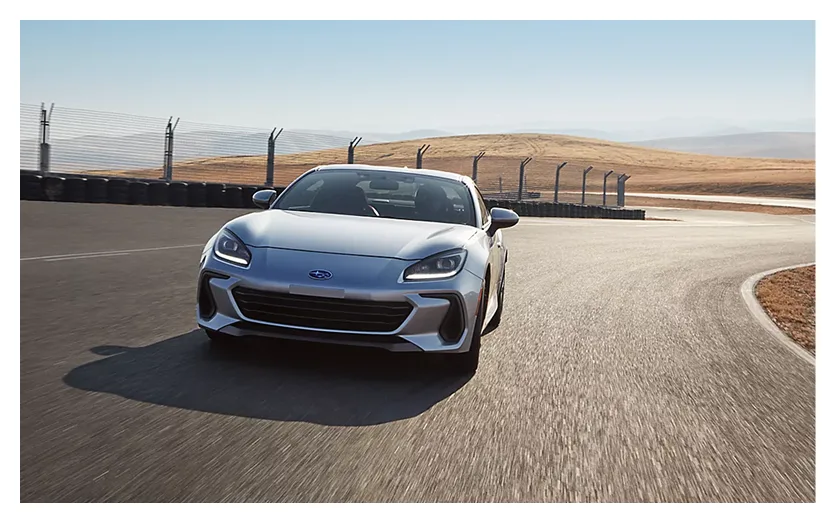 A Subaru BRZ cornering hard on a race circuit