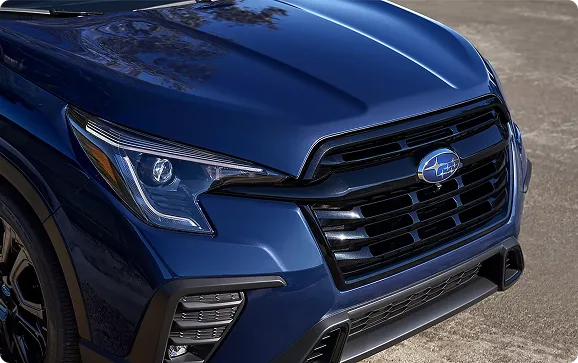 Close-up of the blue Subaru Ascent headlight and gloss black grille