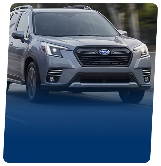 Silver Subaru electric SUV on a blue backdrop
