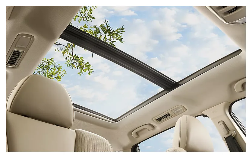 Open panoramic moonroof above the Ascent cabin showing blue sky and clouds