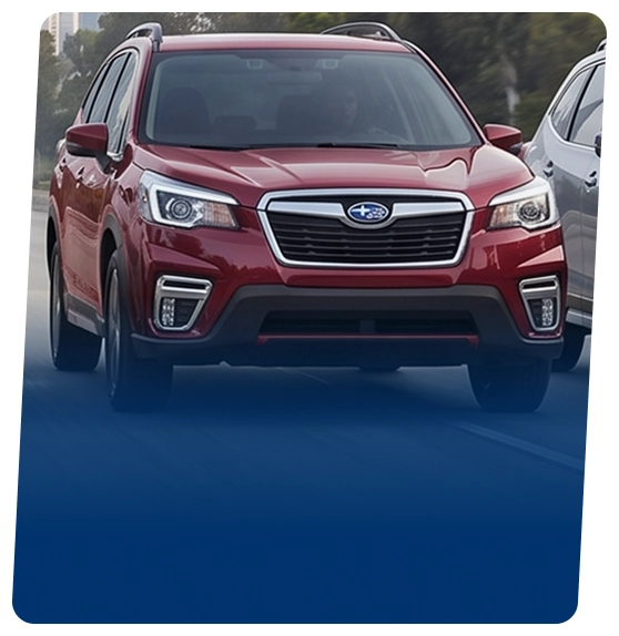 A red Subaru Forester on a city street