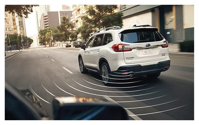 A white Subaru Ascent with blind-spot detection zones highlighted around it