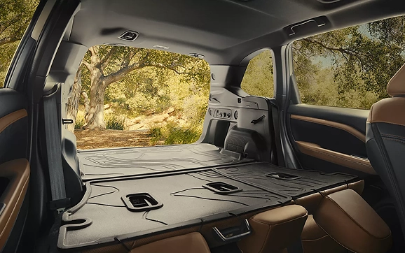 The rear cargo area of a Subaru Forester with the seats folded flat