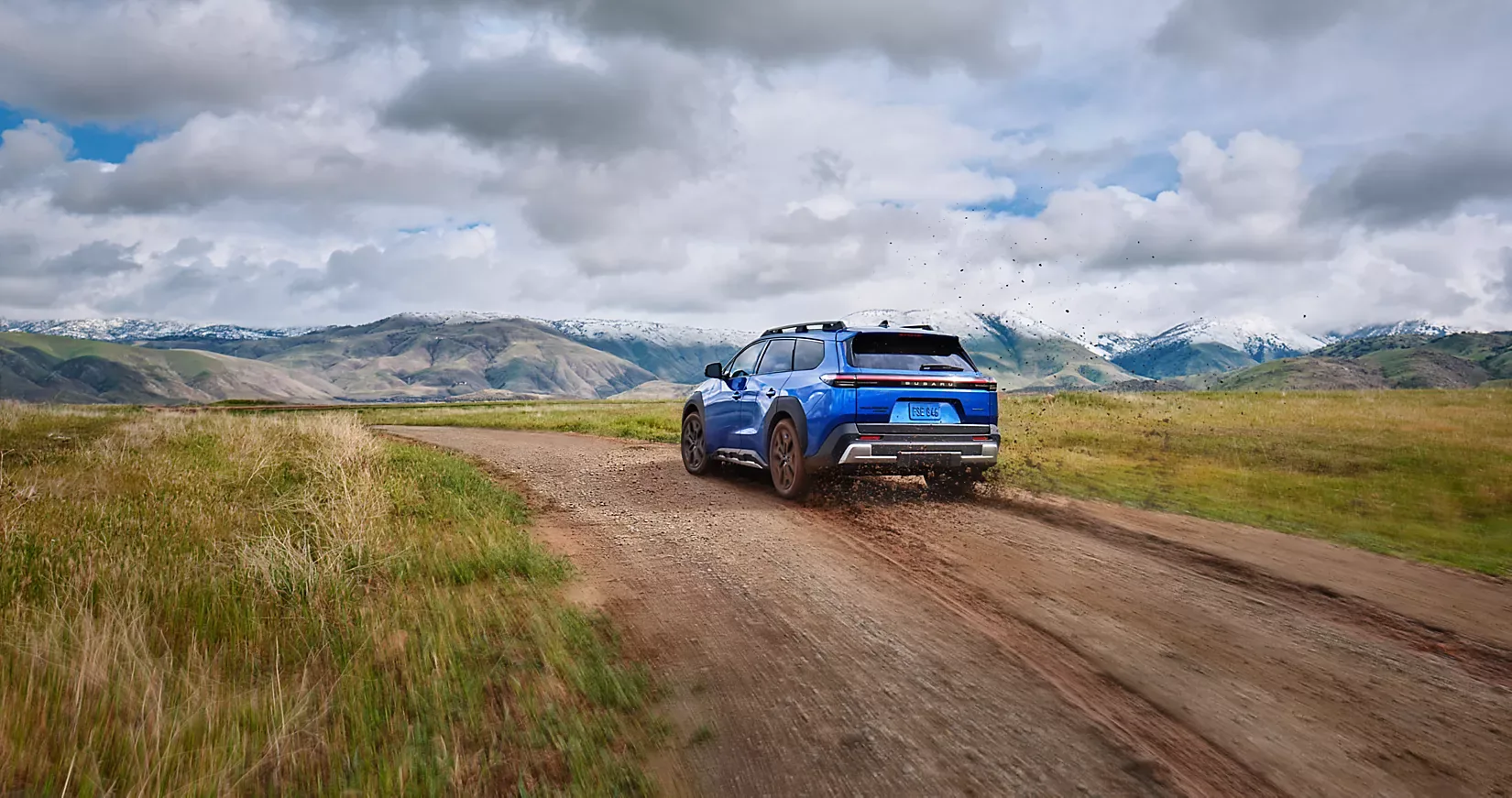 A Subaru Trailseeker travelling a remote road