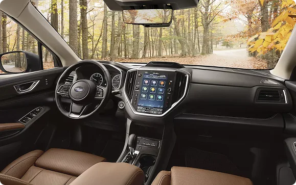 Subaru Ascent dashboard and vertical touchscreen with a forest road ahead