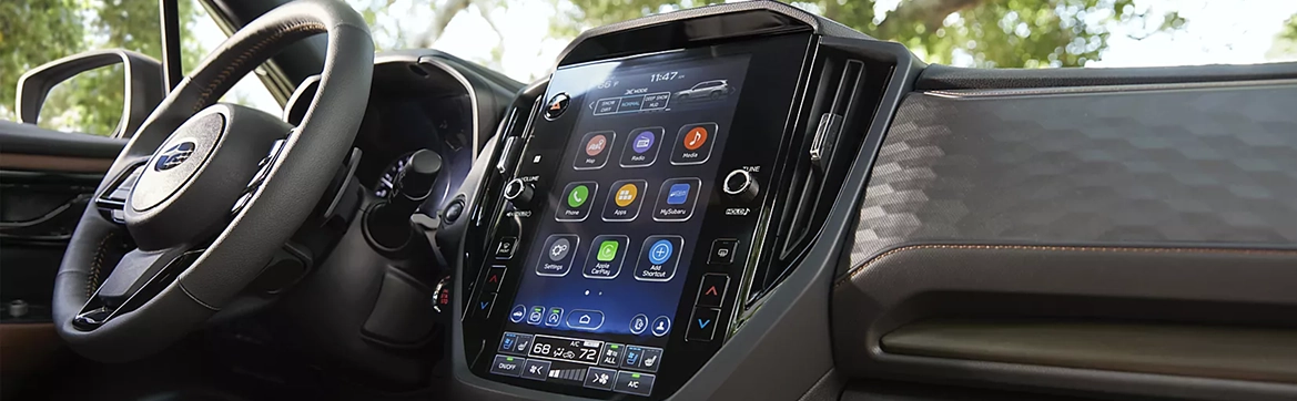 The steering wheel and vertical multimedia touchscreen of a Subaru Forester interior