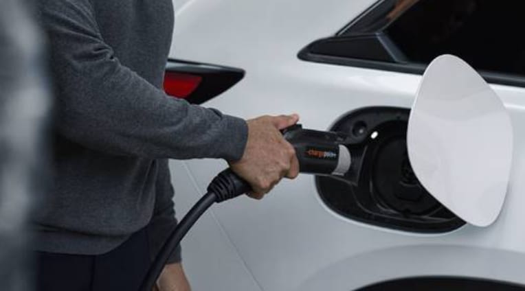 Mazda EV plugged into battery.