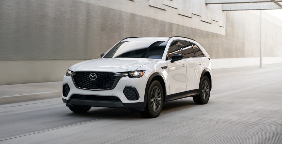 White 2026 MAZDA CX-70 PHEV driving on road.