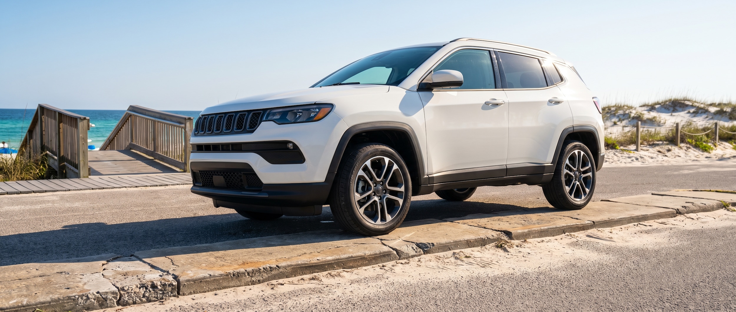 2026 Jeep Compass parked near Panama City Florida beach access road with Gulf Coast in background