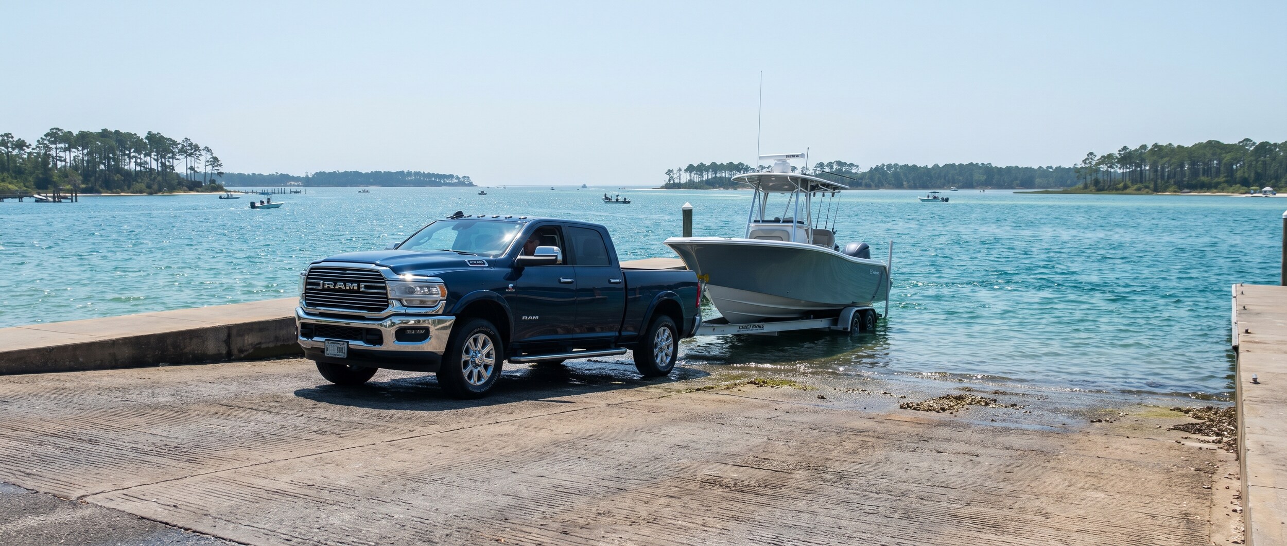 2026 Ram 2500 towing a boat trailer at a Panama City, FL boat ramp on St. Andrews Bay