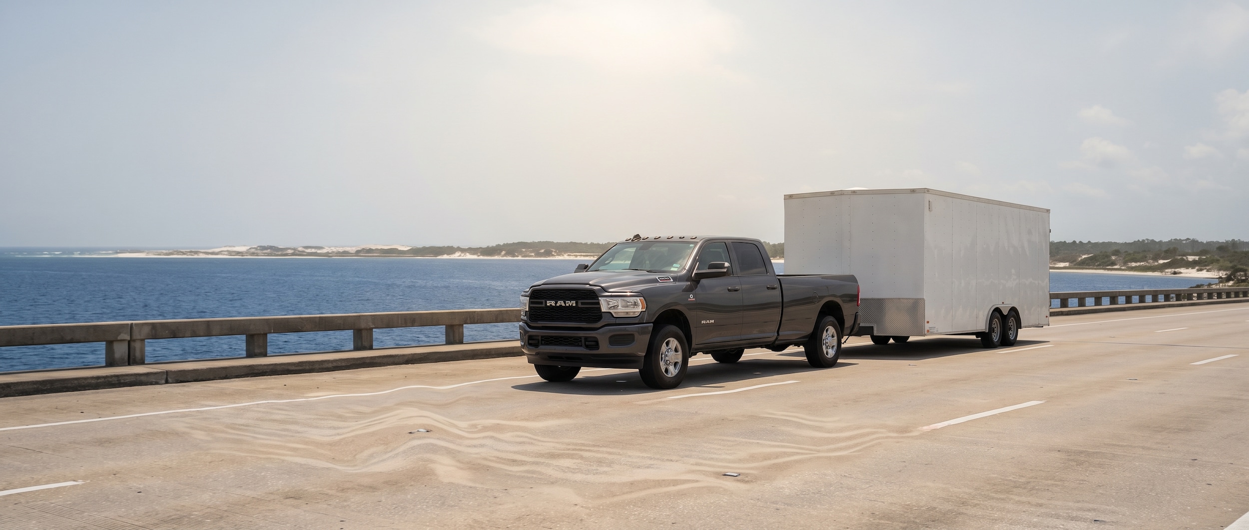 2026 Ram 2500 towing a trailer across a Florida Panhandle bridge on a hot summer day