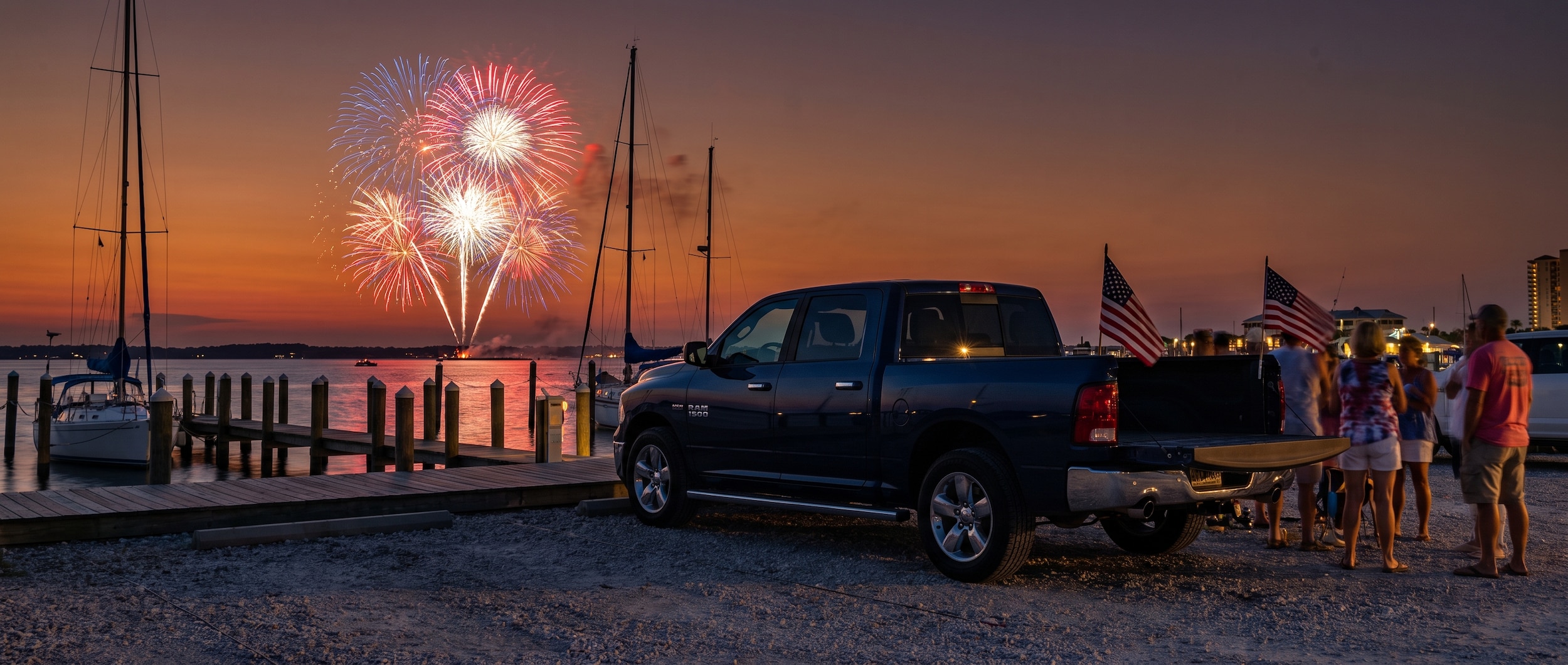 Ram 1500 Crew Cab parked at Panama City Beach marina with fireworks over the water on the Fourth of July