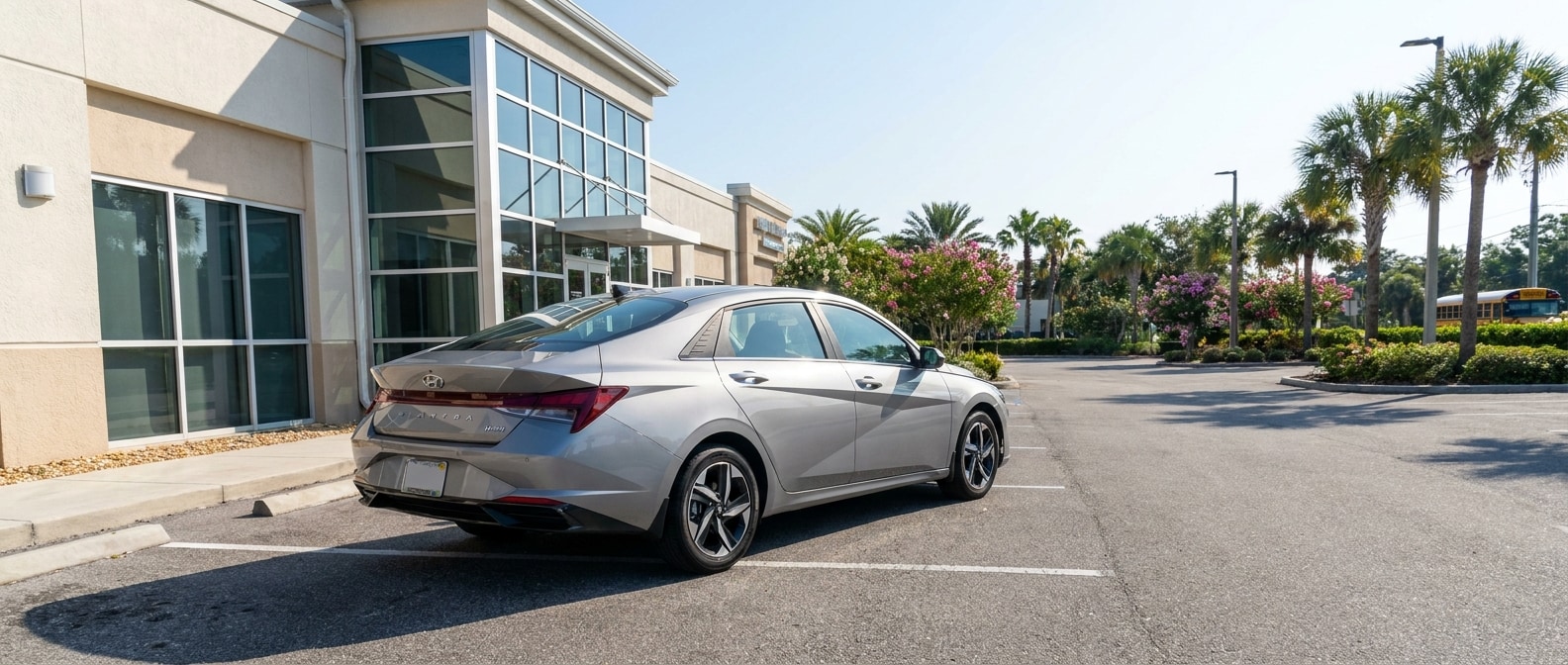 2026 Hyundai Elantra Hybrid parked outside a Bay County, FL school building on a sunny day
