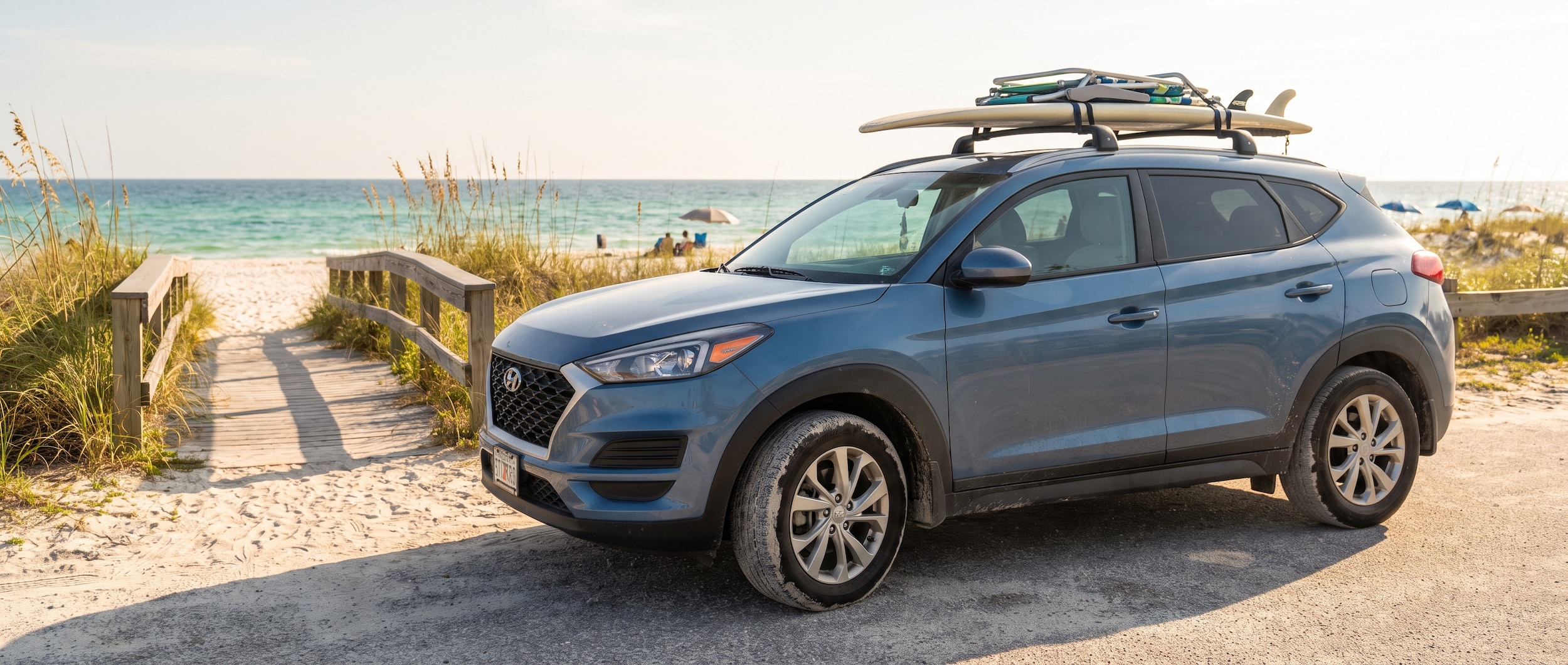 A used Hyundai Tucson parked near a sunny Gulf Coast beach access road in Panama City, FL in 2026, reflecting a practical family SUV in a warm coastal setting