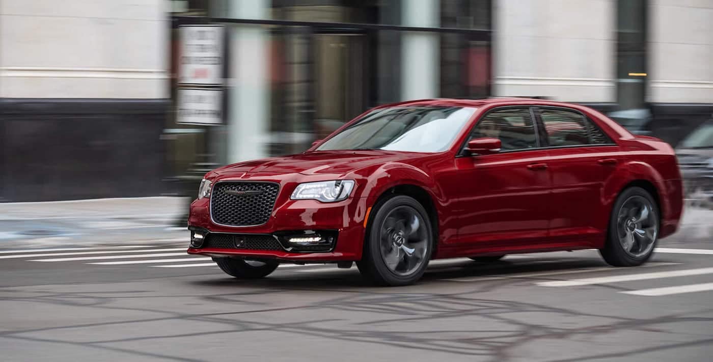 The 2021 Chrysler 300 driving in a city.