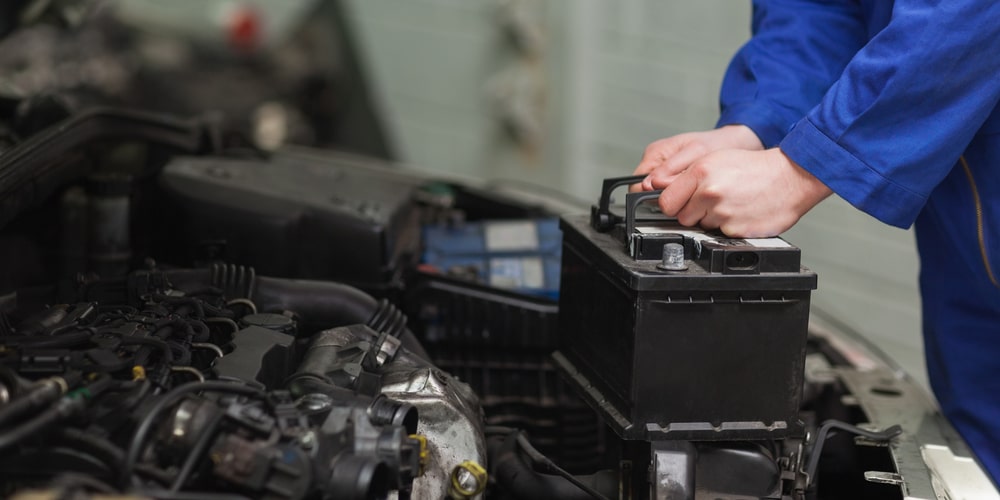 Certified Mopar Technician Performing A Battery Replacement At Our King George Service center