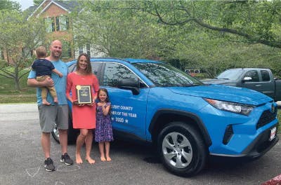 family-in-front-of-blue-toyota.jpeg